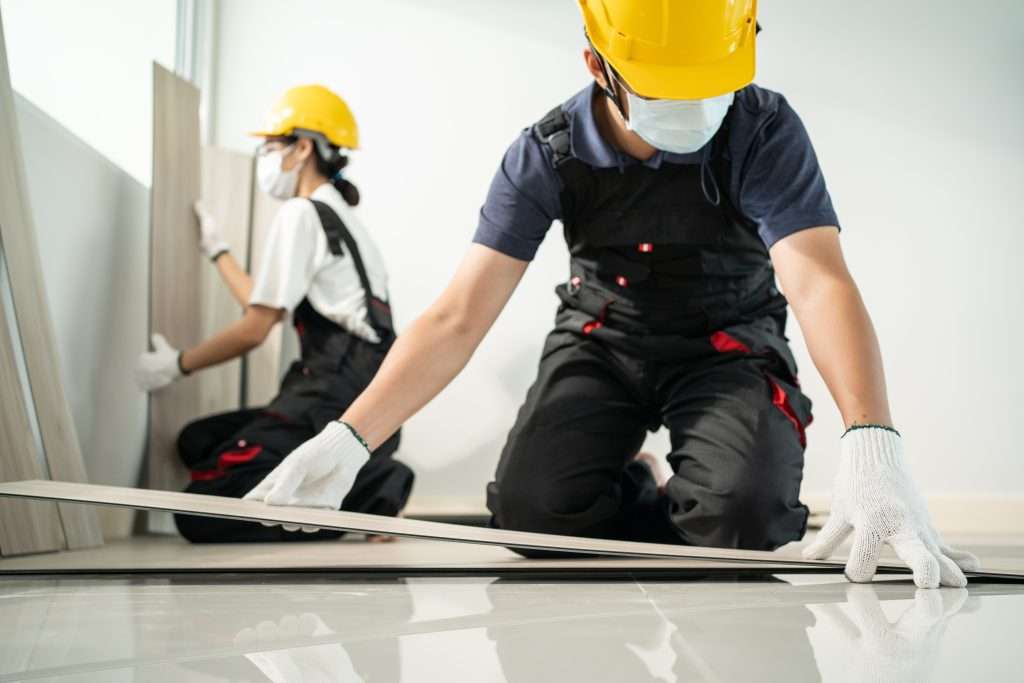 Asian Construction worker wear mask installs laminate board on floor Gallery - 13